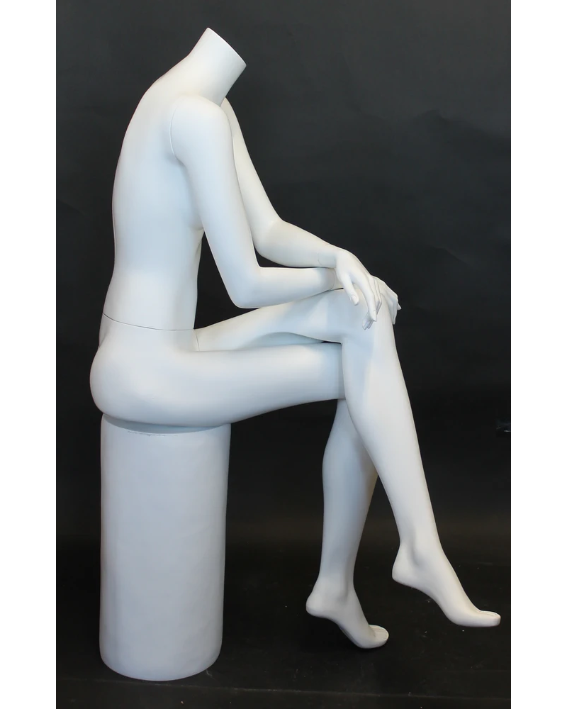Crossed-leg seated headless female mannequin in matte white