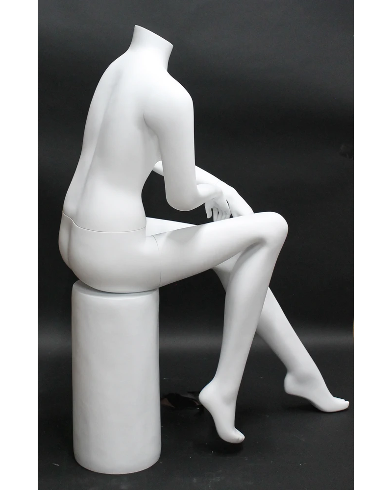 Seated headless female mannequin in matte white
