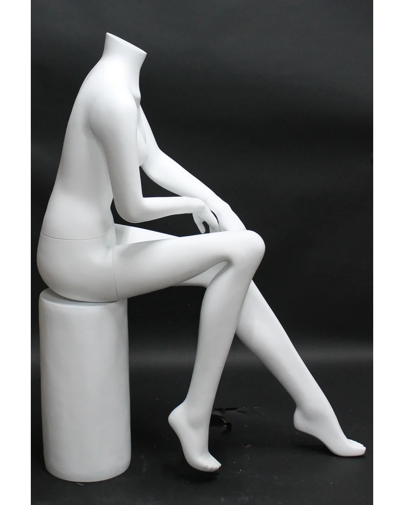 Seated headless female mannequin in matte white