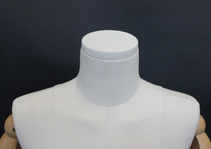 Size 4 female half body linen dress form with egg head, wooden arms and 4-wheel chrome base